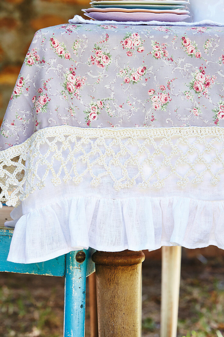 Pretty tablecloth with floral pattern, crocheted border and flounce
