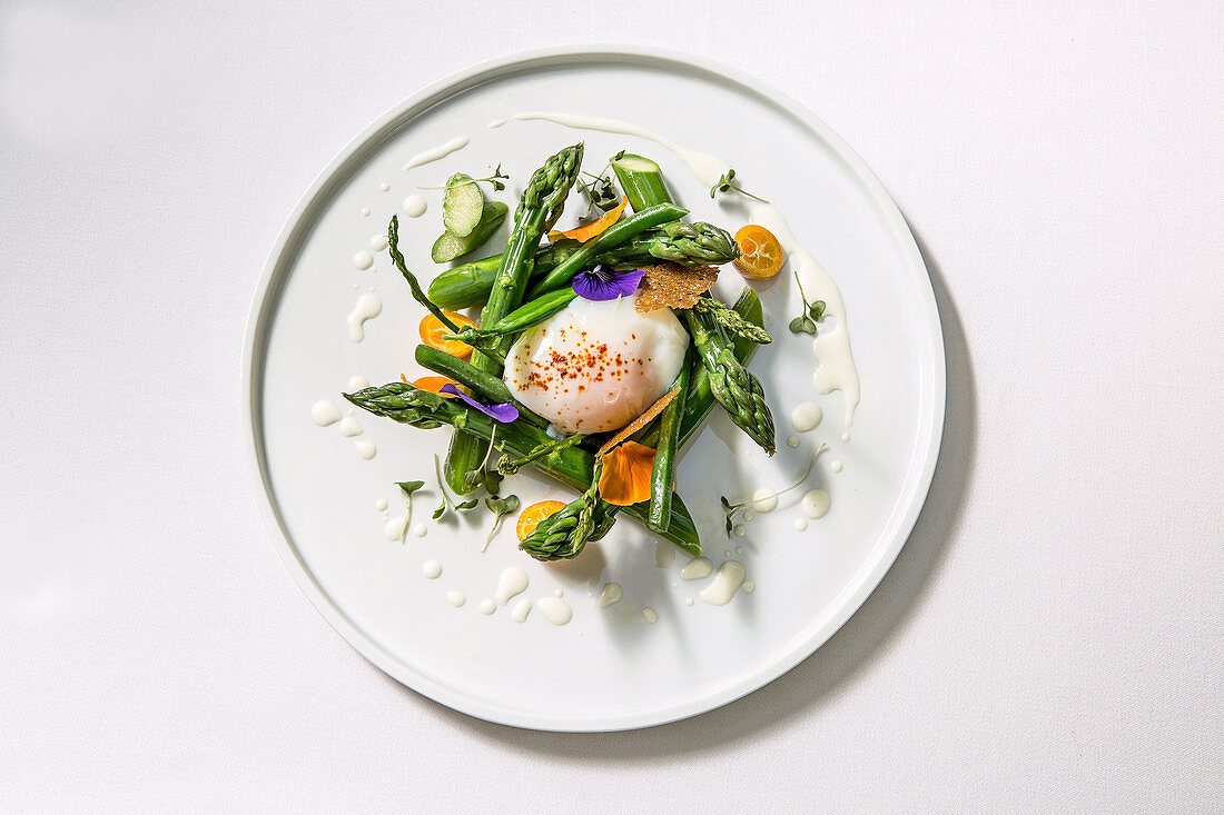Softly poached egg with green vegetable and kumquats