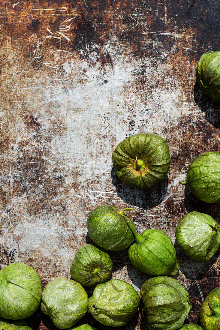 Tomatillos on a rusty surface