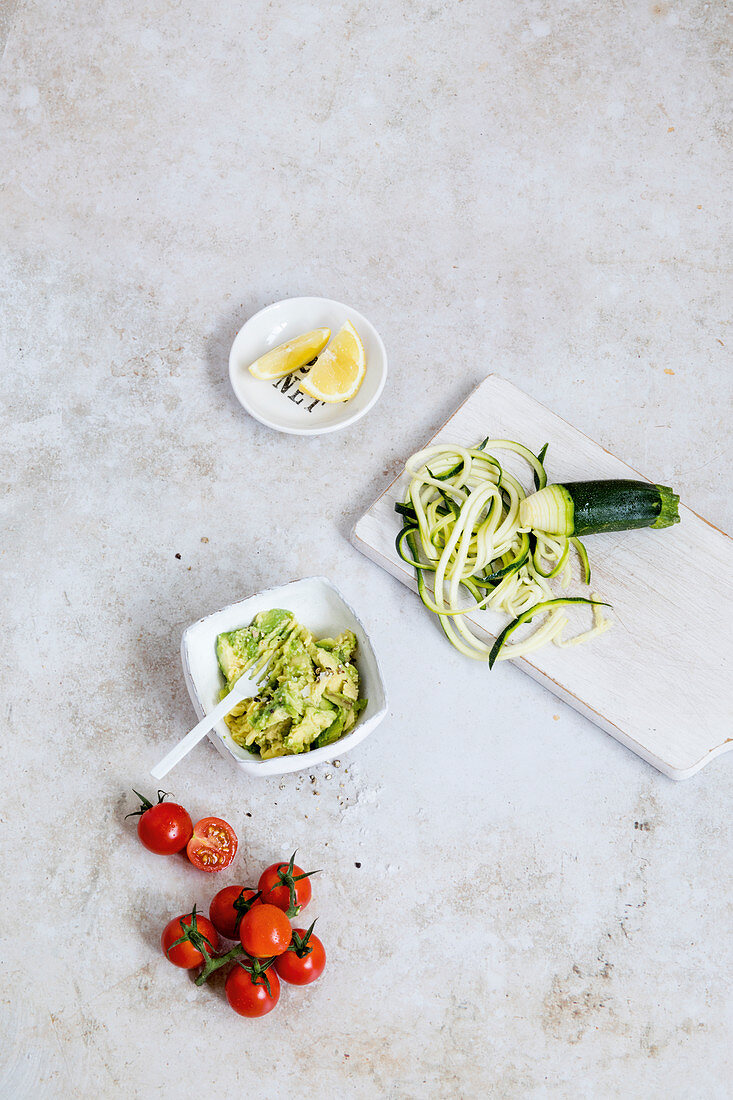 Ingredients for zoodles with avocado and tomatoes