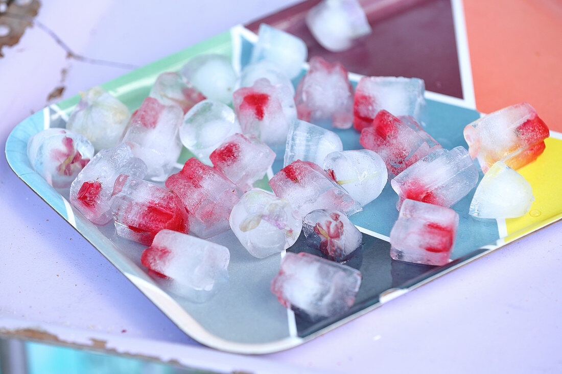 Ice cubes with strawberries on a tray