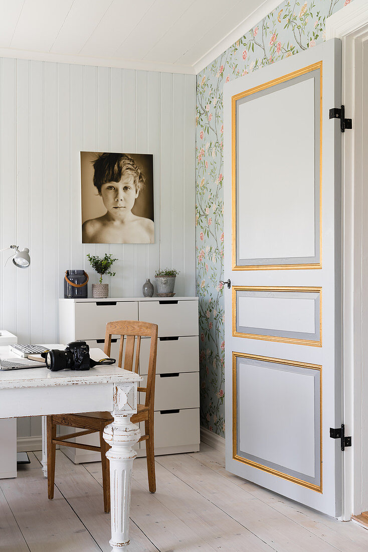 Painted panelled door leading into hobby room in Scandinavian country-house style