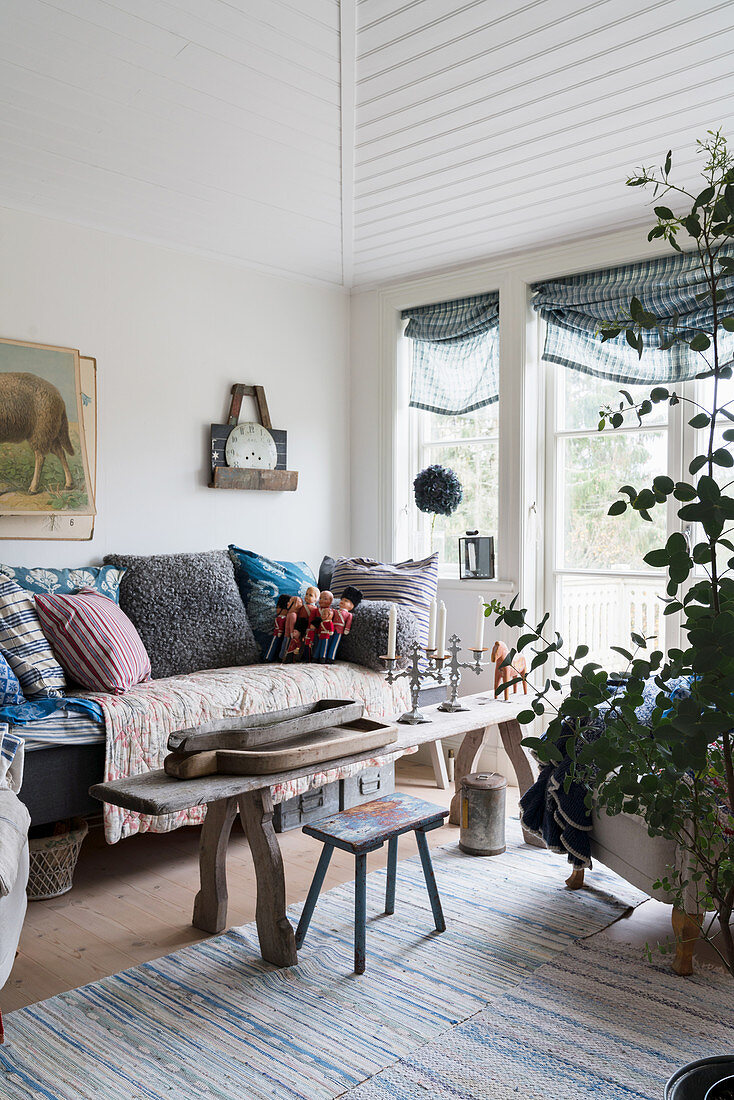 Old wooden bench used as coffee table in country-house-style living room