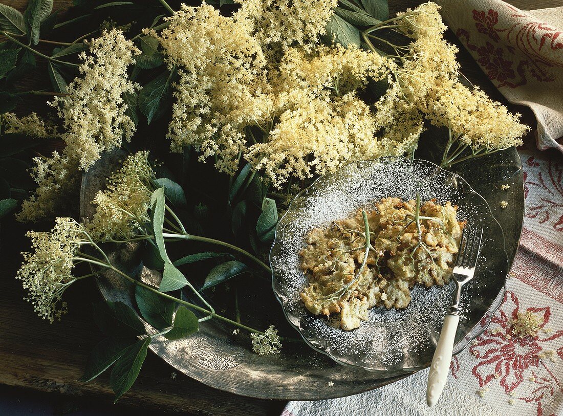 Deep-fried elderflowers on plate & fresh elderflowers