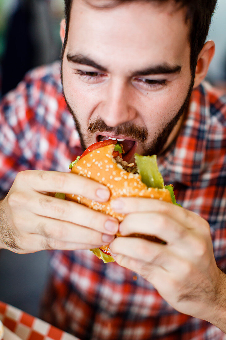 Man eating juicy lucy burger