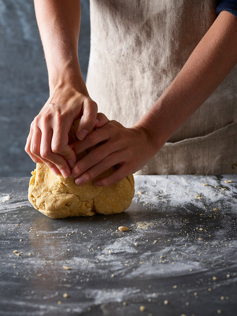 Preparing pasta dough: knead pasta on a floured surface