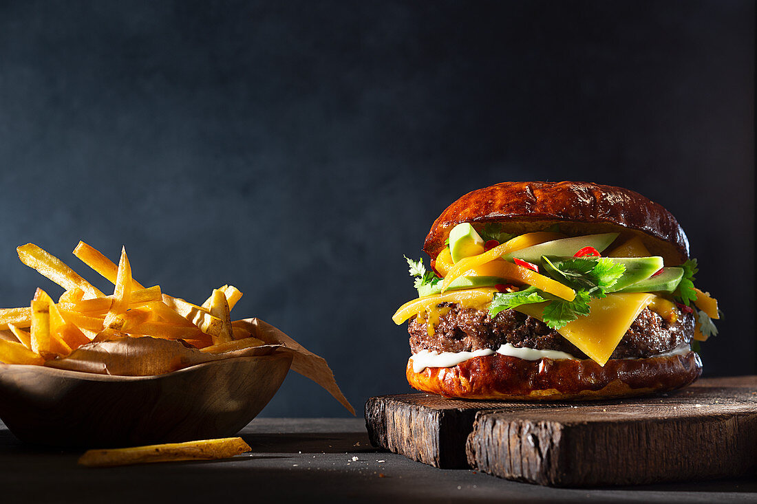 Burger with mango and avocado, served with fries