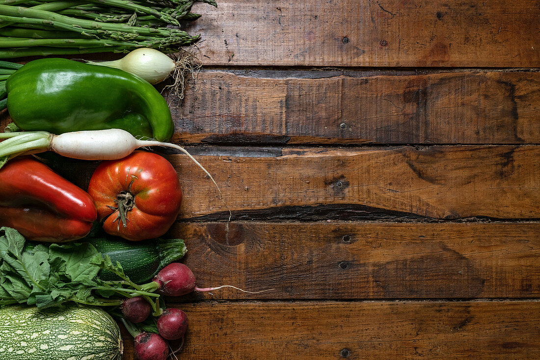 Fresh organic vegetables on a dark wooden table