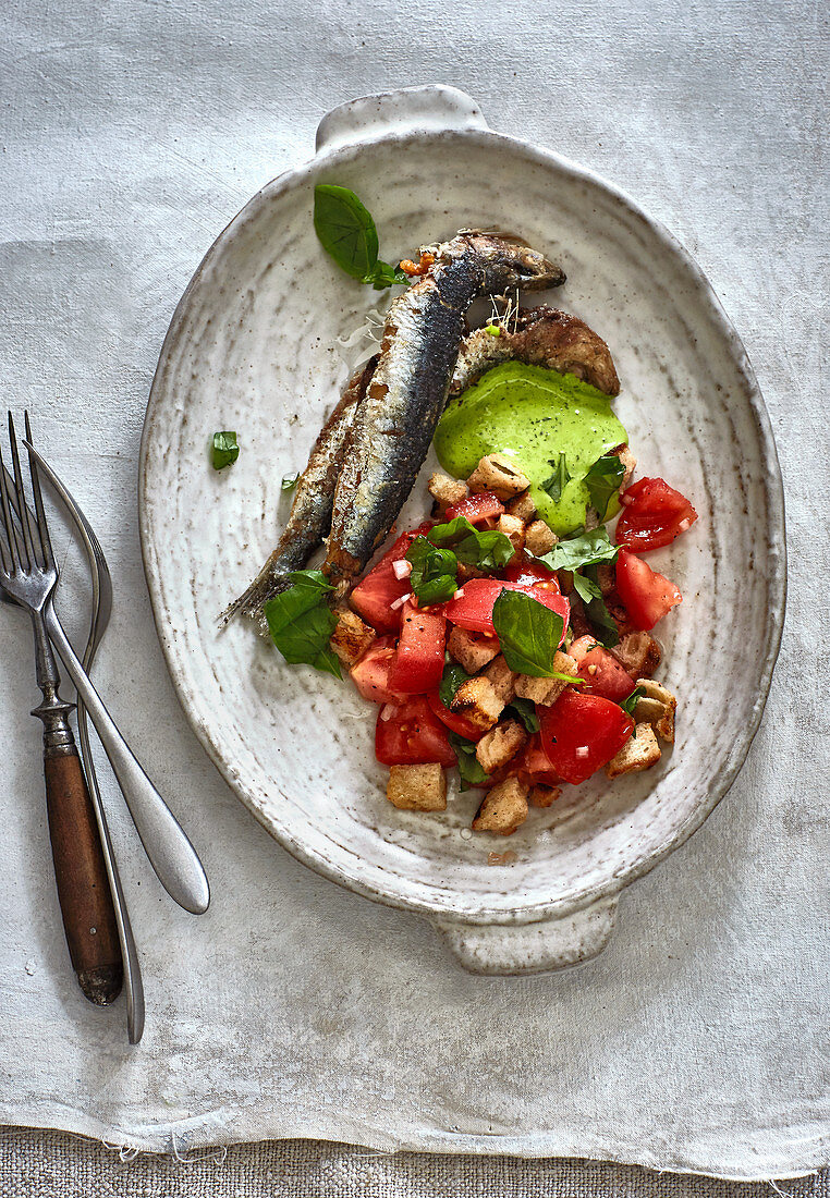 Baked anchovies with a tomato and bread salad and green mayonnaise