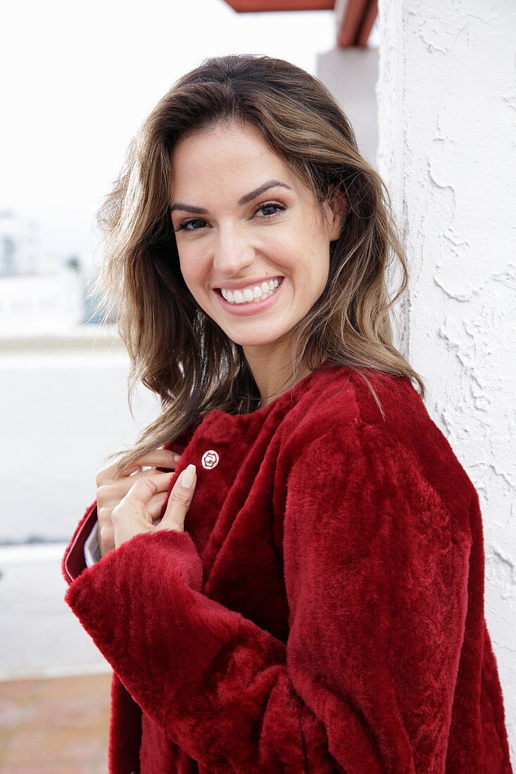 A young woman wearing a red coat