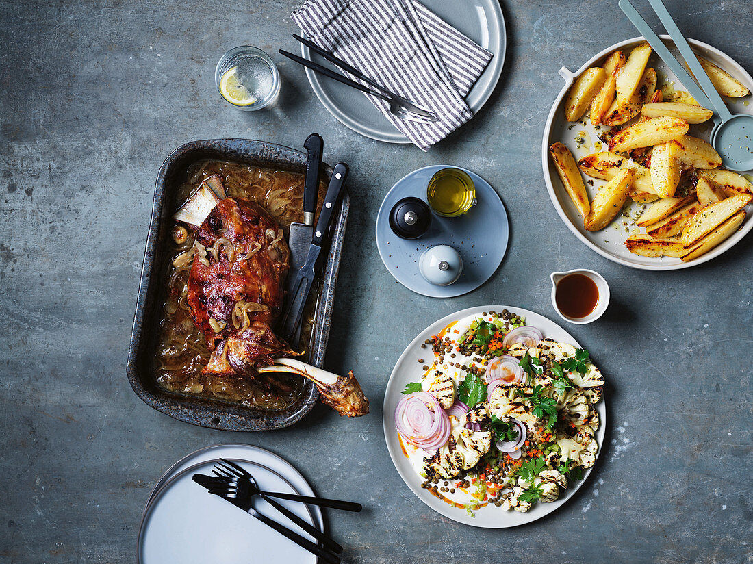 Greek slow-cooked lamb shoulder with 40 cloves of garlic, barbecued cauliflower-lentil-salad and potato wedges