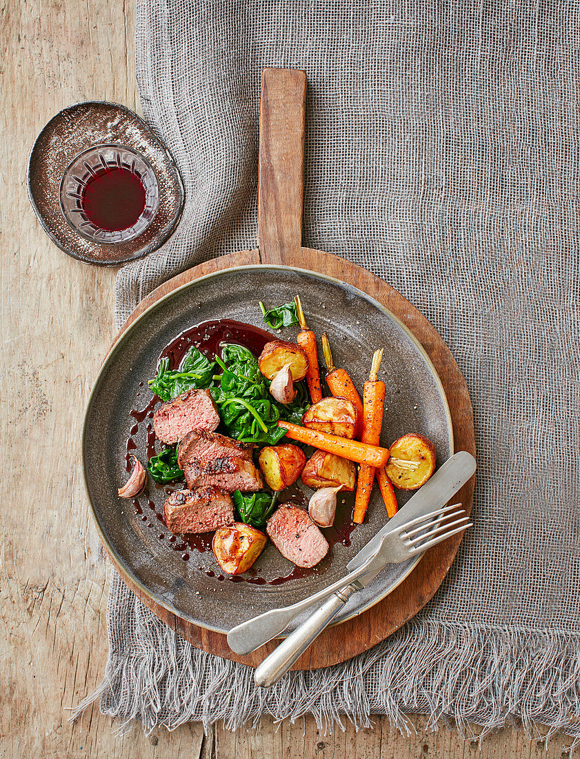 Loin of lamb, wilted spinach, carrots and rosemary potatoes