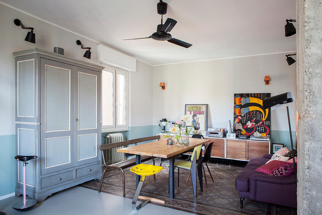 Dining table, sideboard and sofa in retro living space