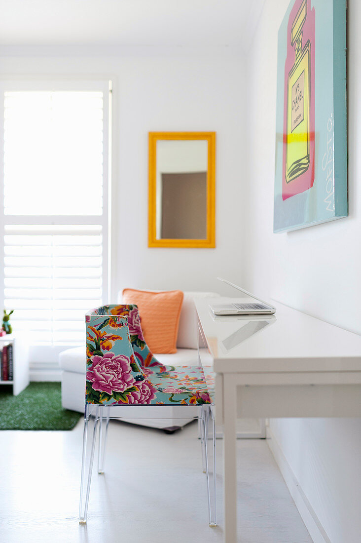 Simple white desk with colourful chair, armchair and mirror