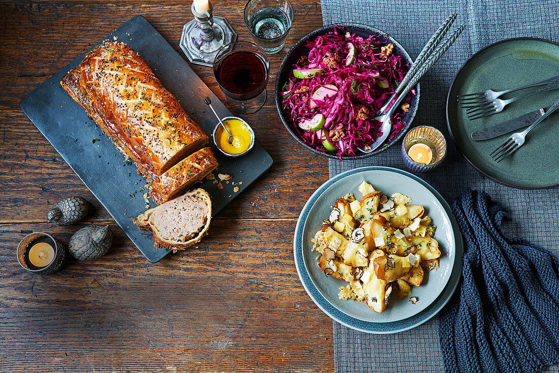 Toulouse sausage roll, pickled red cabbage with walnuts and apples, baked potato skins with brie and truffle