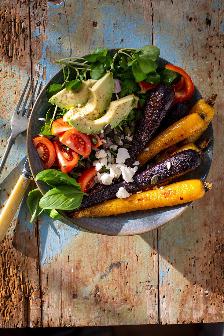 Vegetable bowl with roasted carrots, avocado and feta