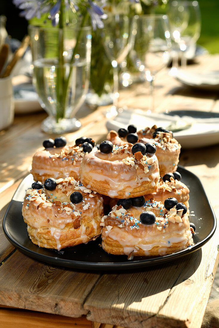 Doughssants with lemon glaze, blueberries and almonds