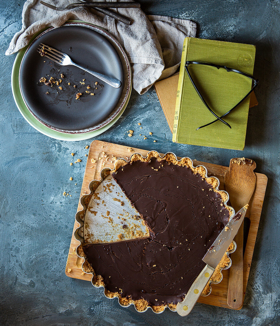 Chocolate tart with biscuit base and slice removed