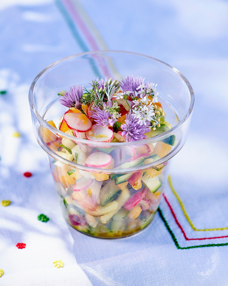 Vegetable salad with fruit and chive flowers
