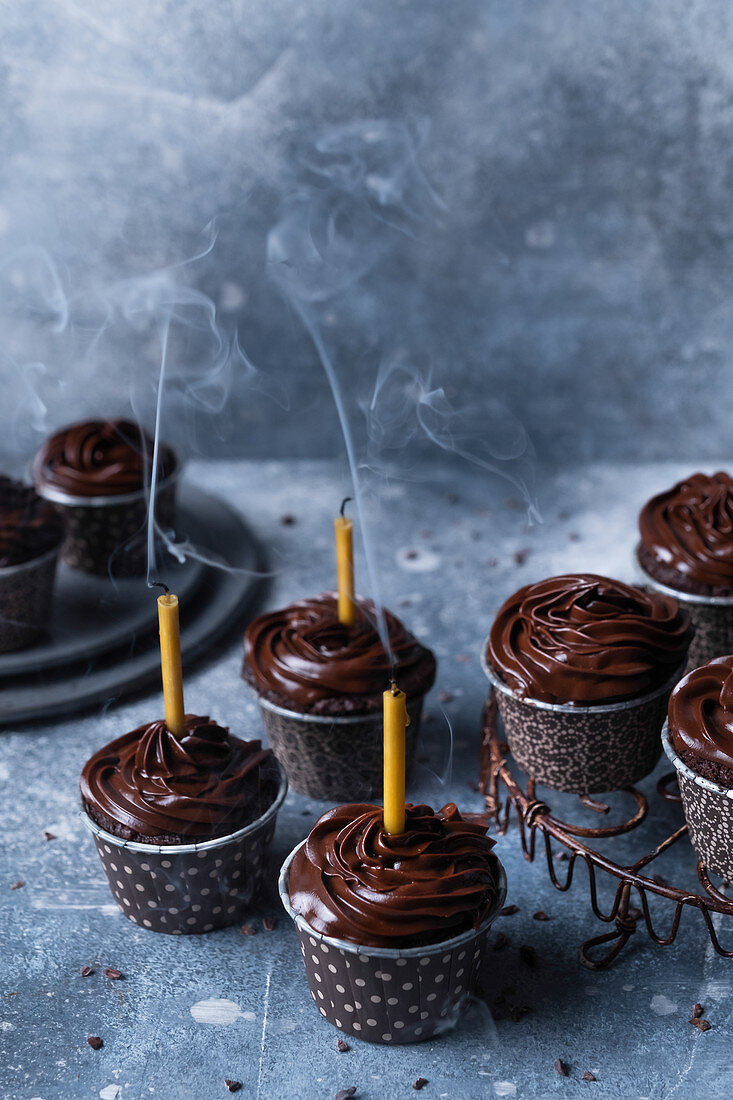 Chocolate muffins with blown candles