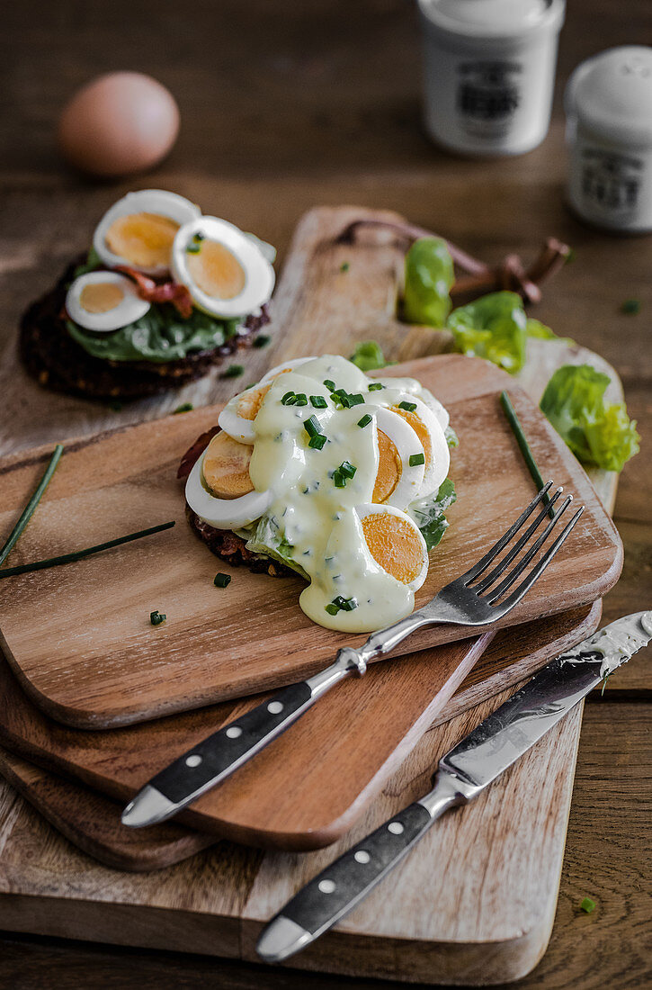 Belegtes Schwarzbrot mit gekochten Eiern und Schnittlauchsauce