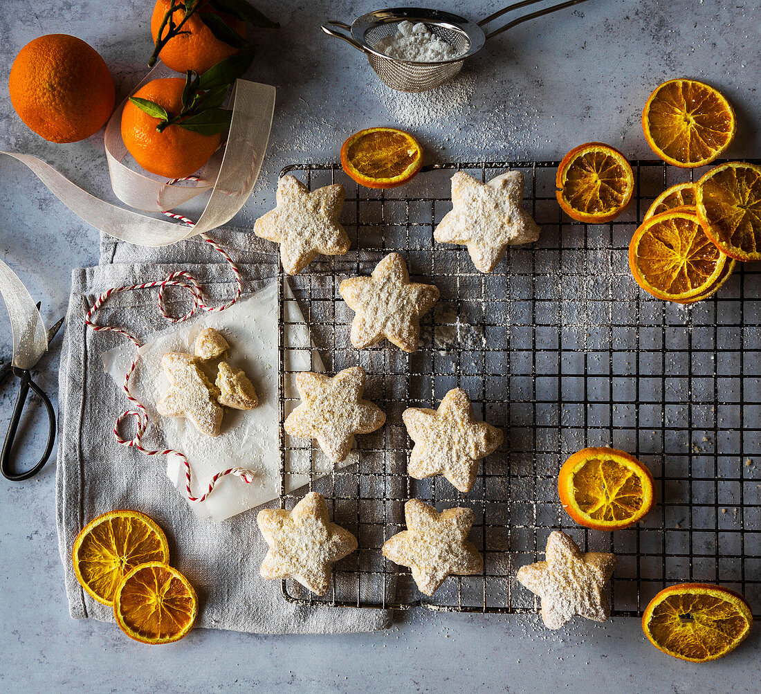Shortbread Star biscuits with icing sugar and orange slices