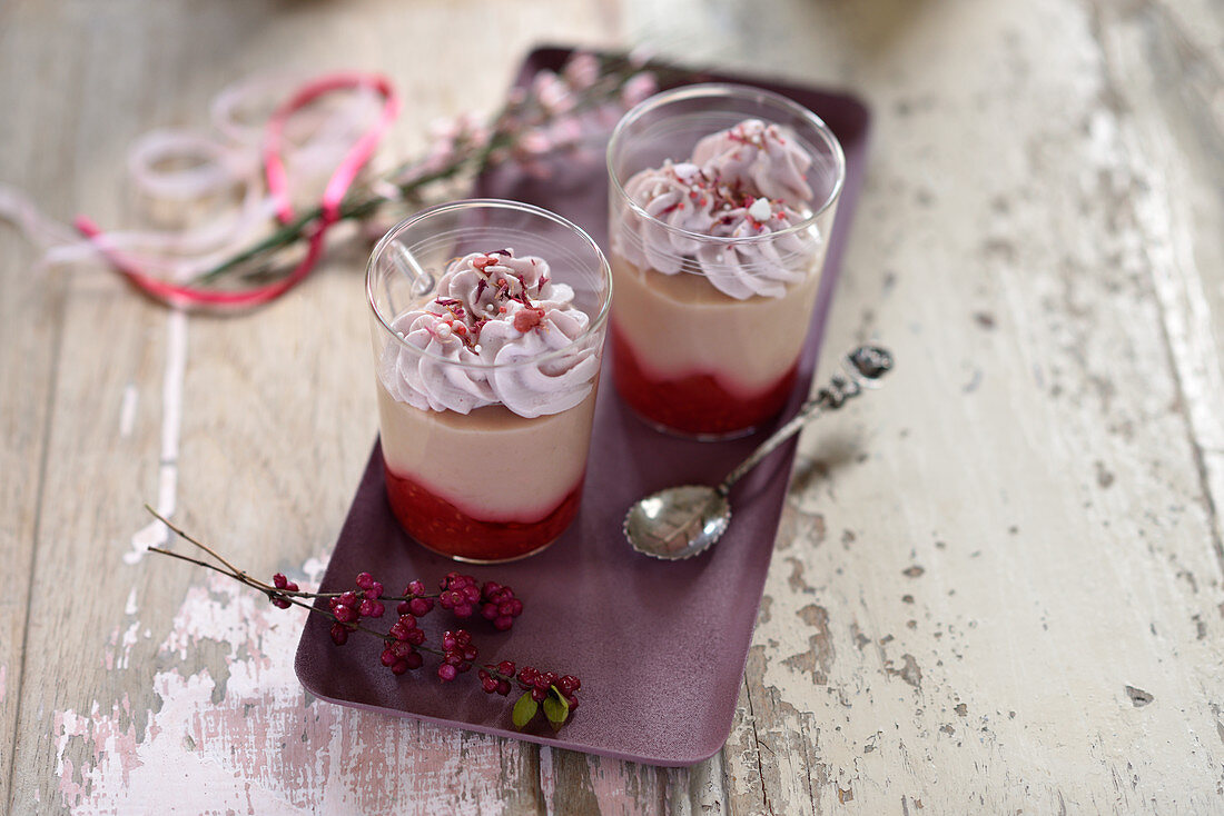 Vegan layered desserts in glasses with raspberries, guava coconut pudding and cherry cream