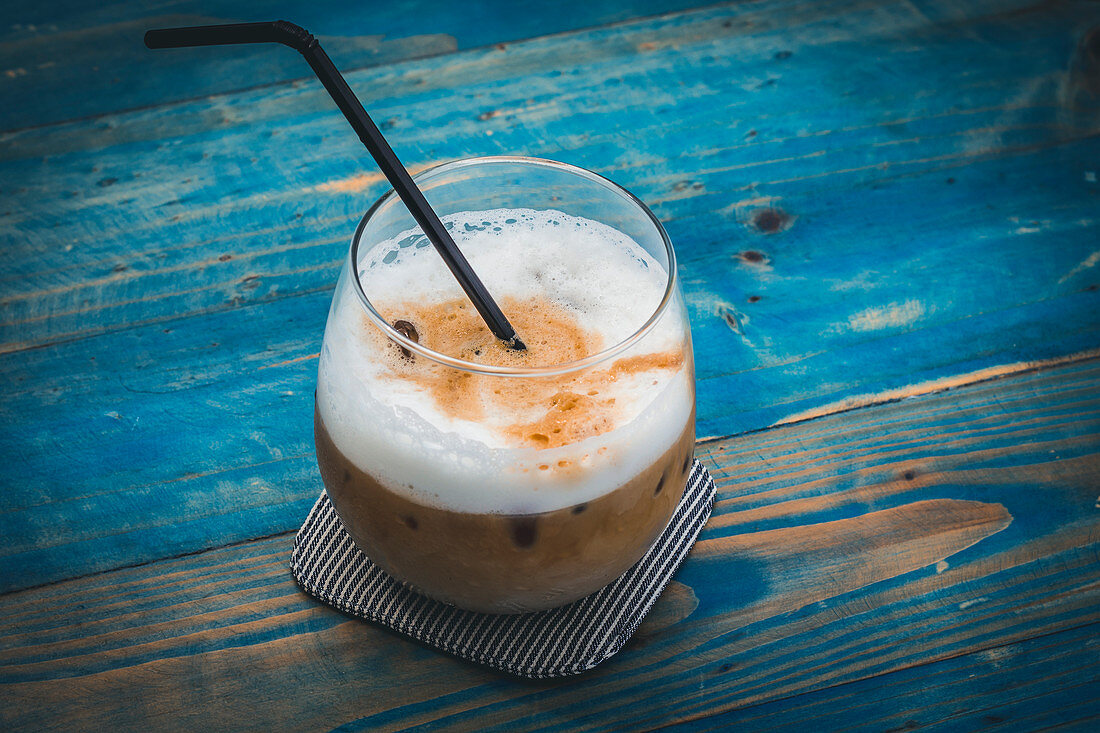 Iced latte on a blue wooden table