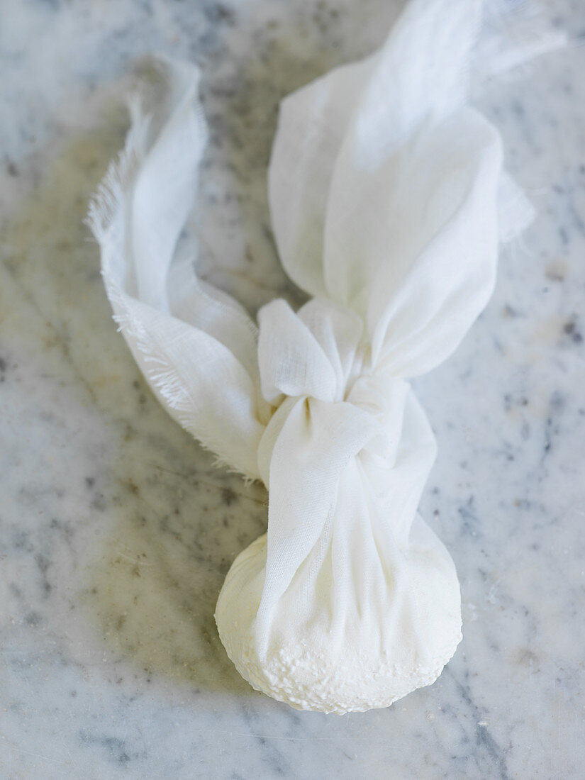 Soft cheese in muslin