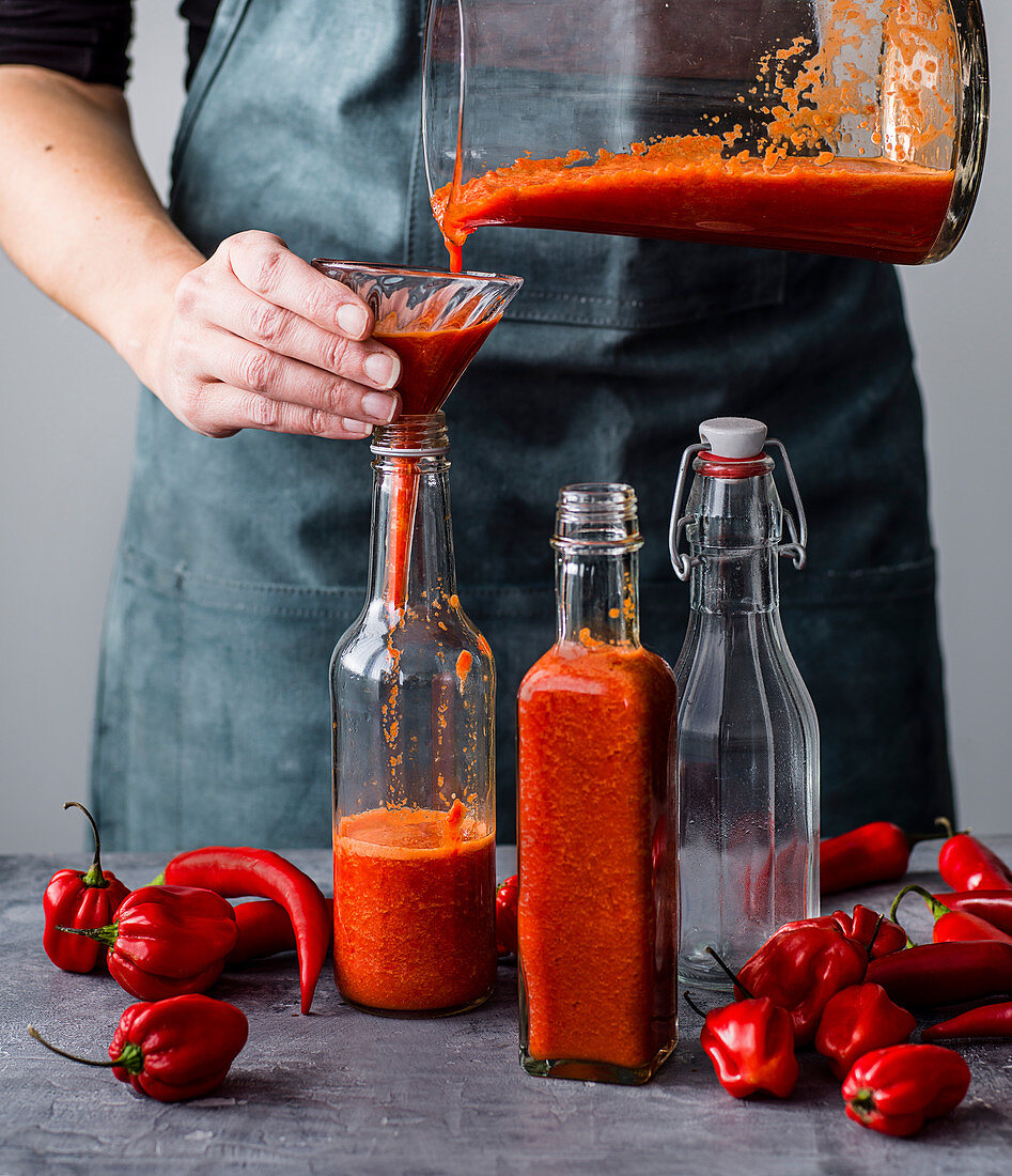 Filling homemade chilli sauce in bottles