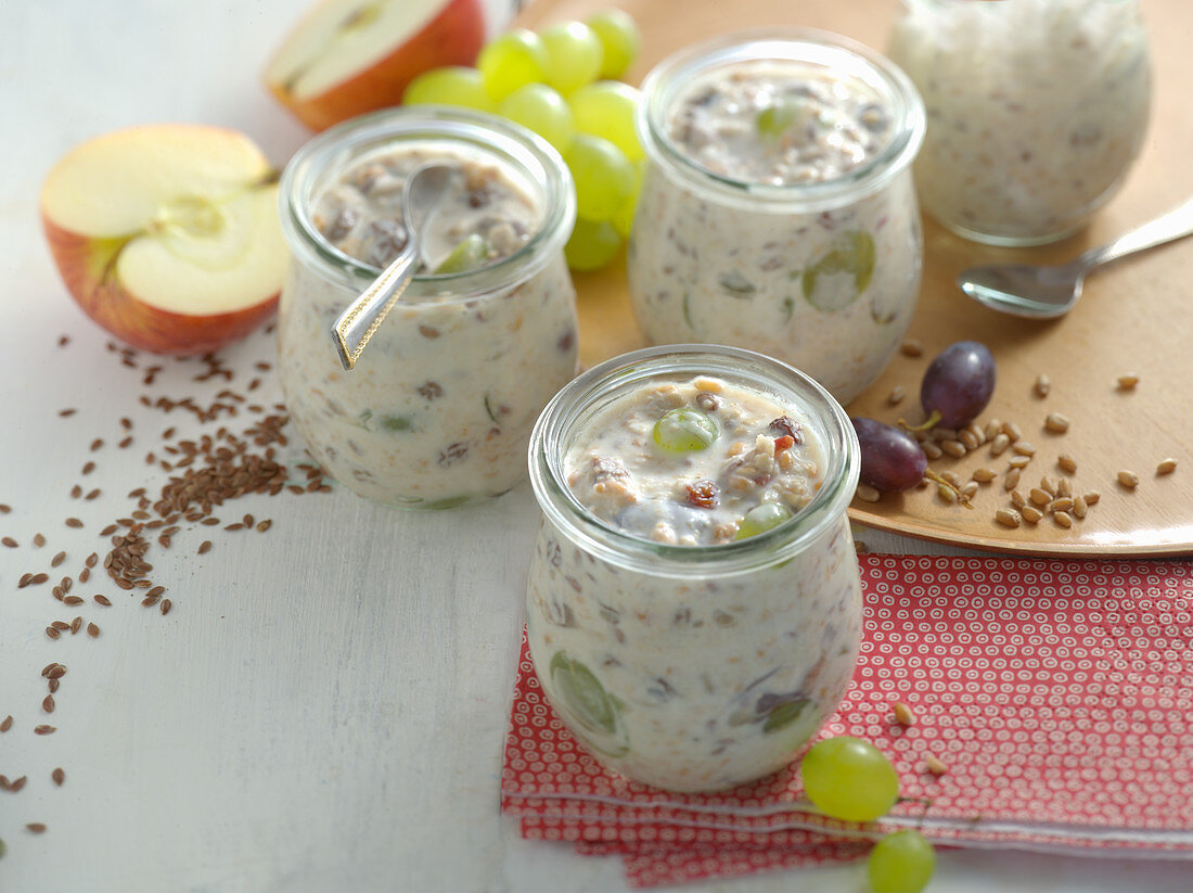 Autumnal fresh grain muesli with apples and grapes in a glass
