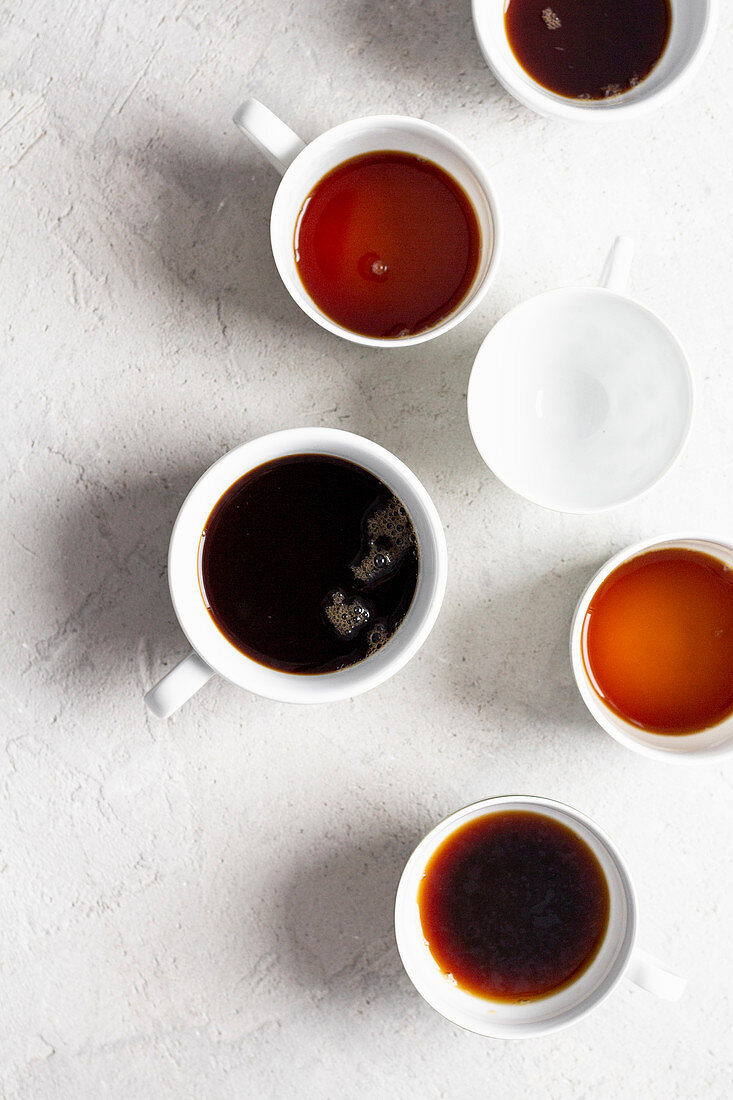 Coffee cups, filled to different levels