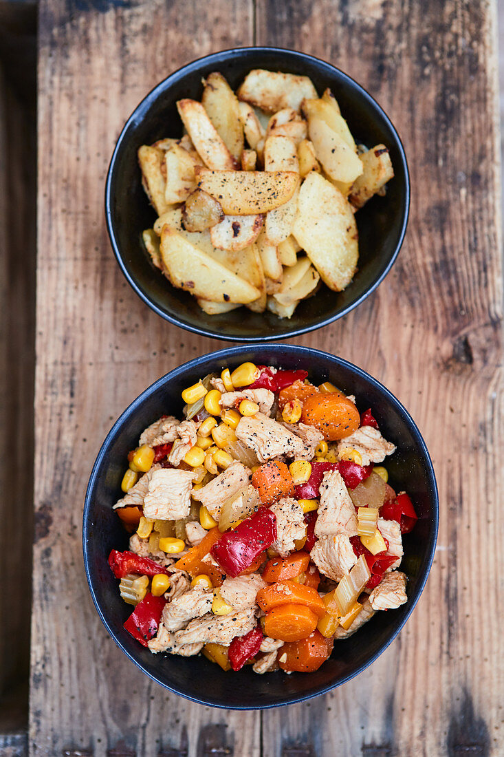 Chicken and vegetable dishes with fried potatoes