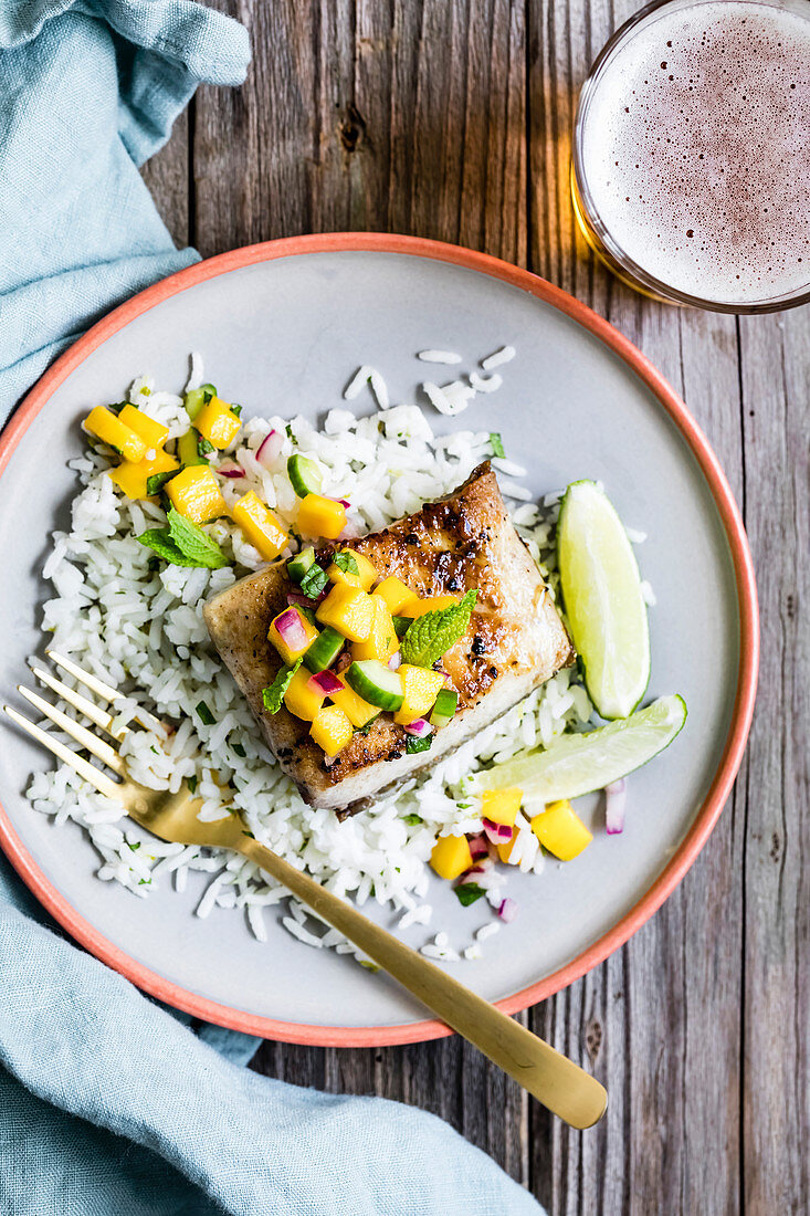 Pan fried fish with a mango salad topping