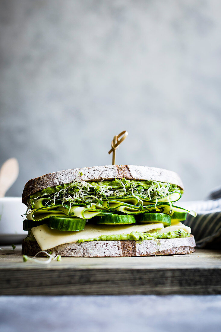 A healthy cheese and green salad sandwich on brown bread, with cucumber and cress