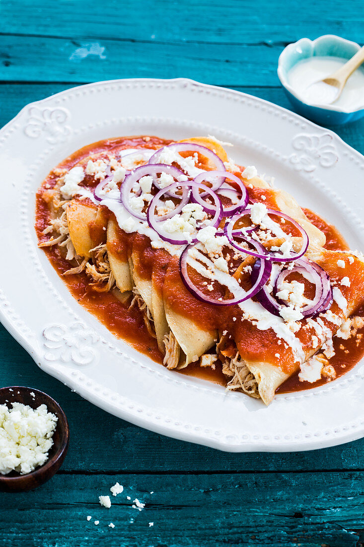 Soft tortillas with tomatoes sauce, filled with chicken, diffrent toppings can be add like sour cream, onions, cheese, guacamole, etc.