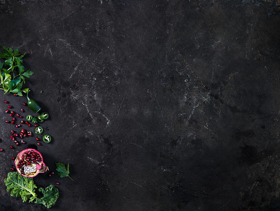 Kale, pomegranate, jalapeno and parsley background