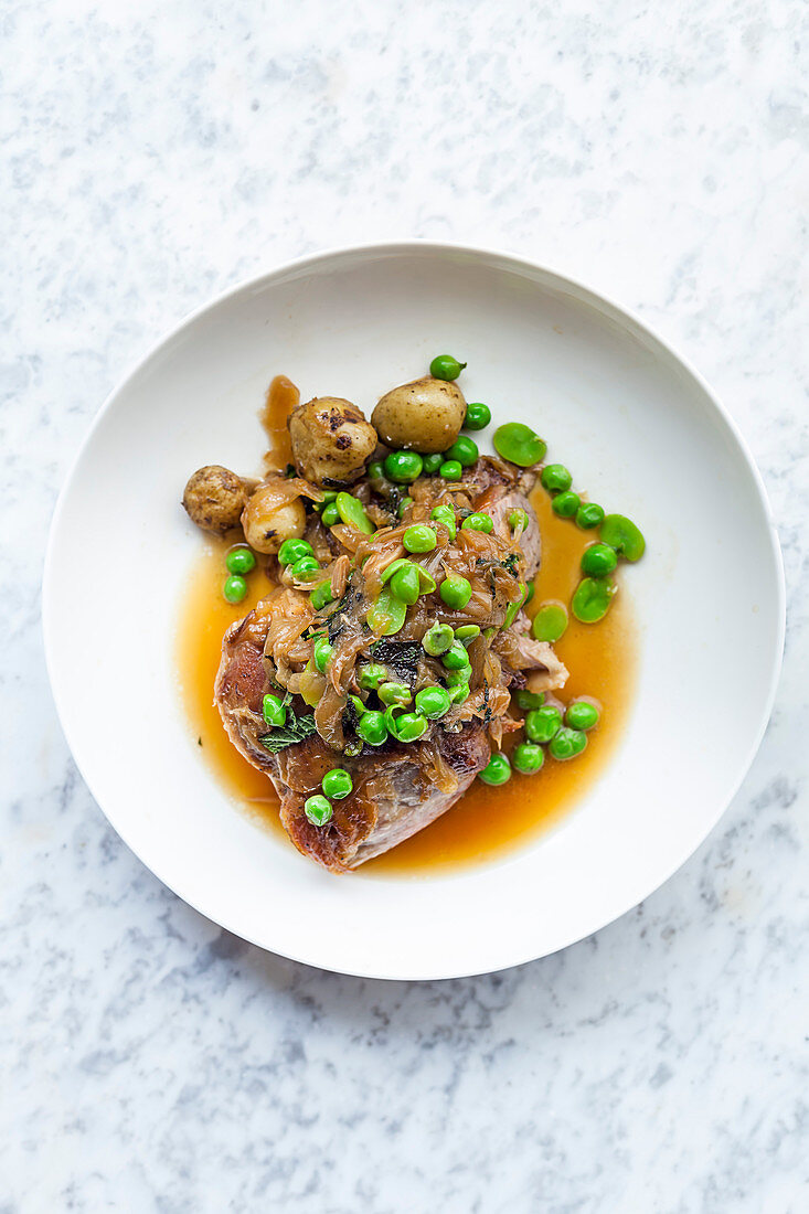 Slow-cooked shoulder of spring lamb, peas, broad beans and min