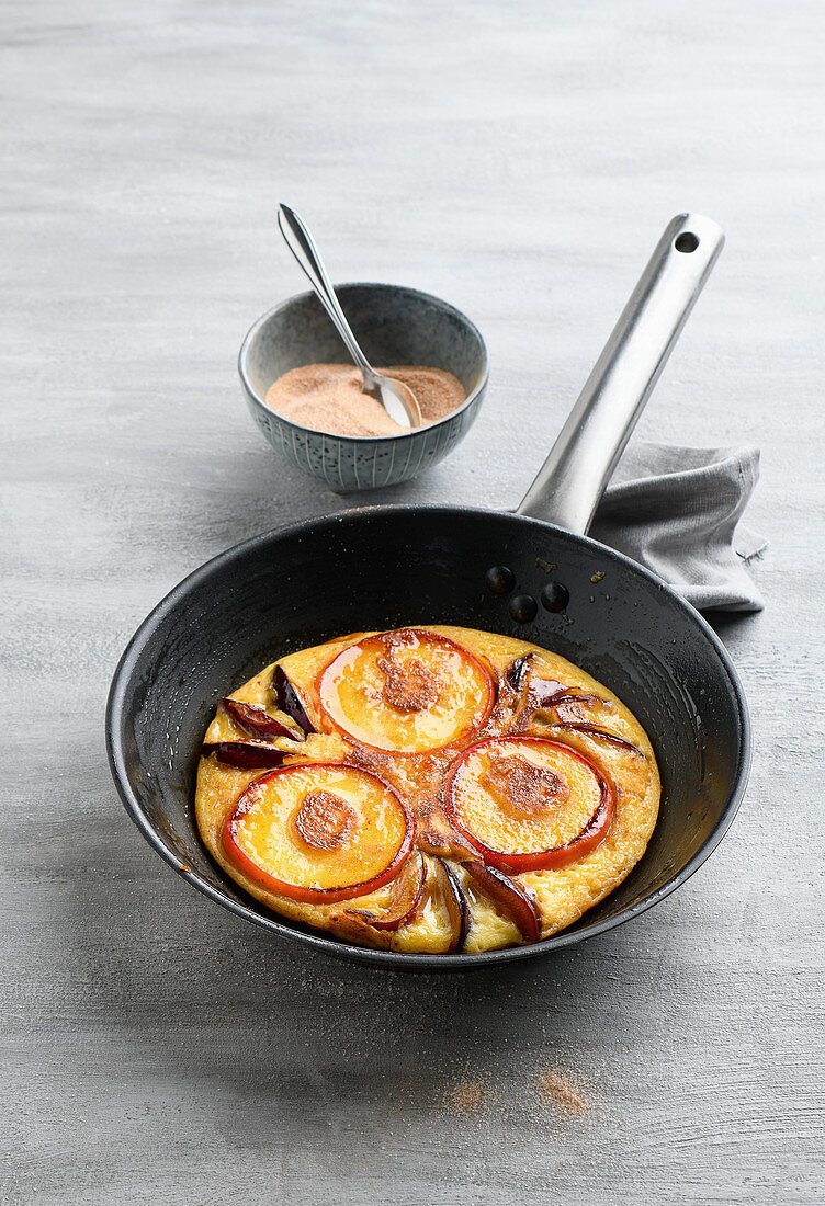 Yeast pancakes with apples and plums