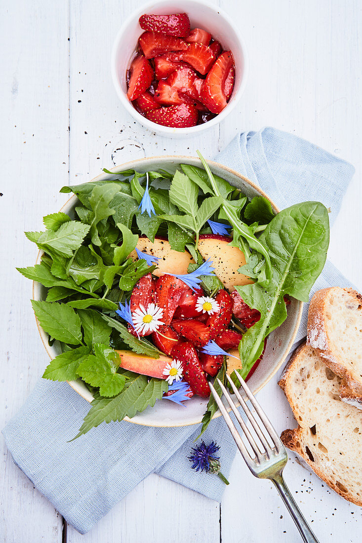 Wild herb salad with marinated strawberries