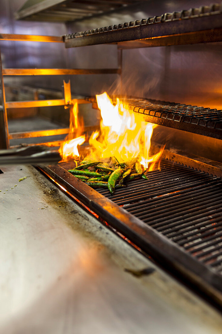 Grilling peas on a professional BBQ