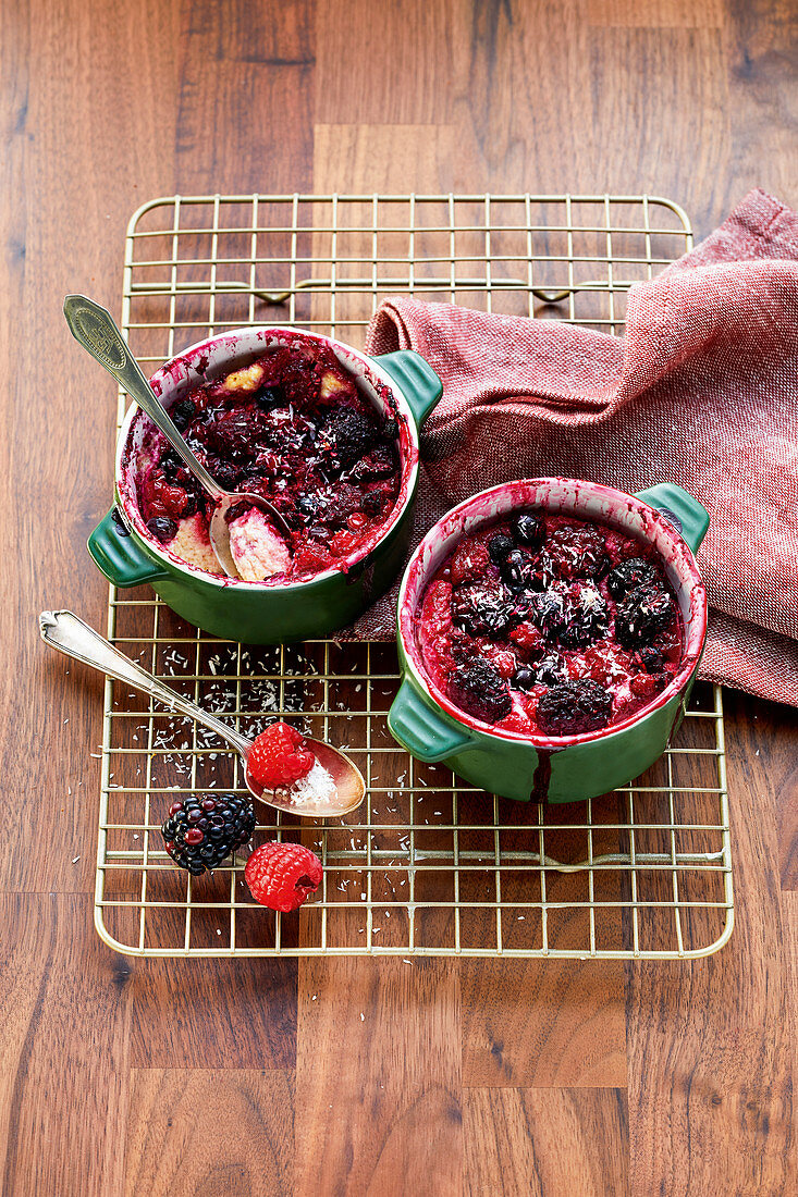 Small berry puddings with coconut topping