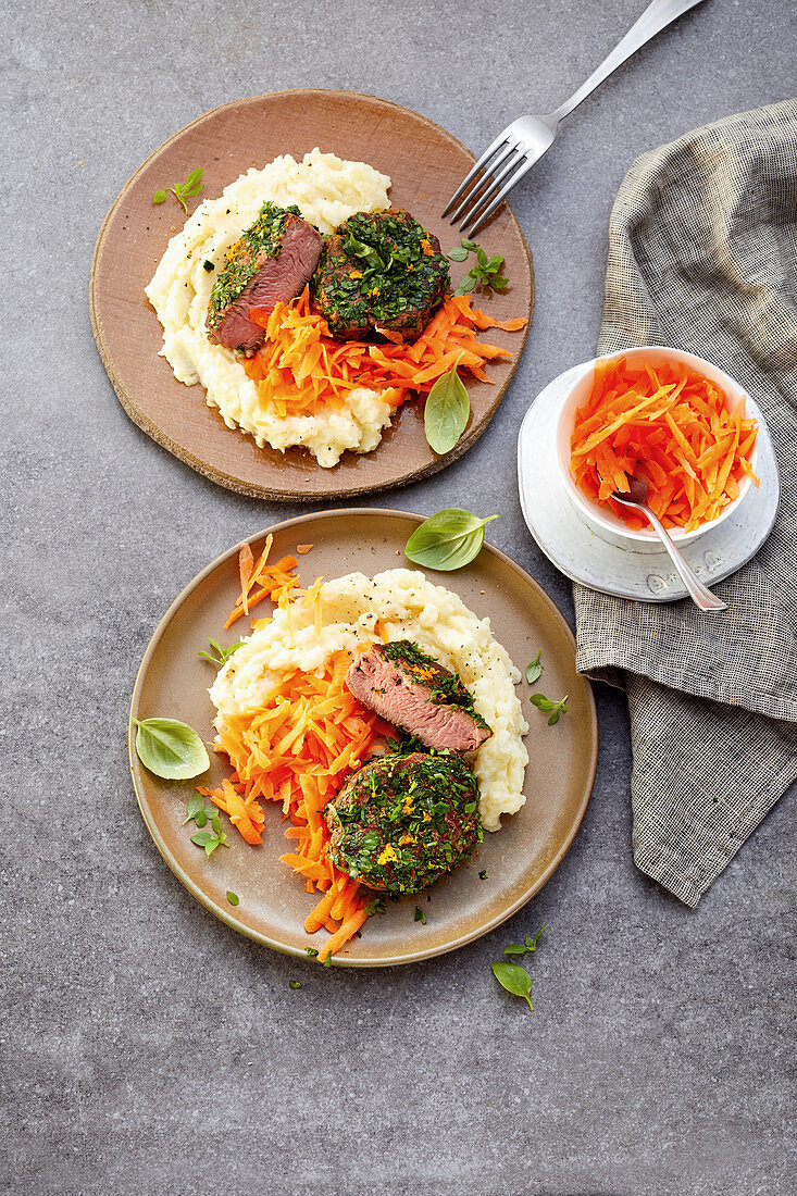 Veal medallions in a herb crust with carrot salad and mashed potatoes