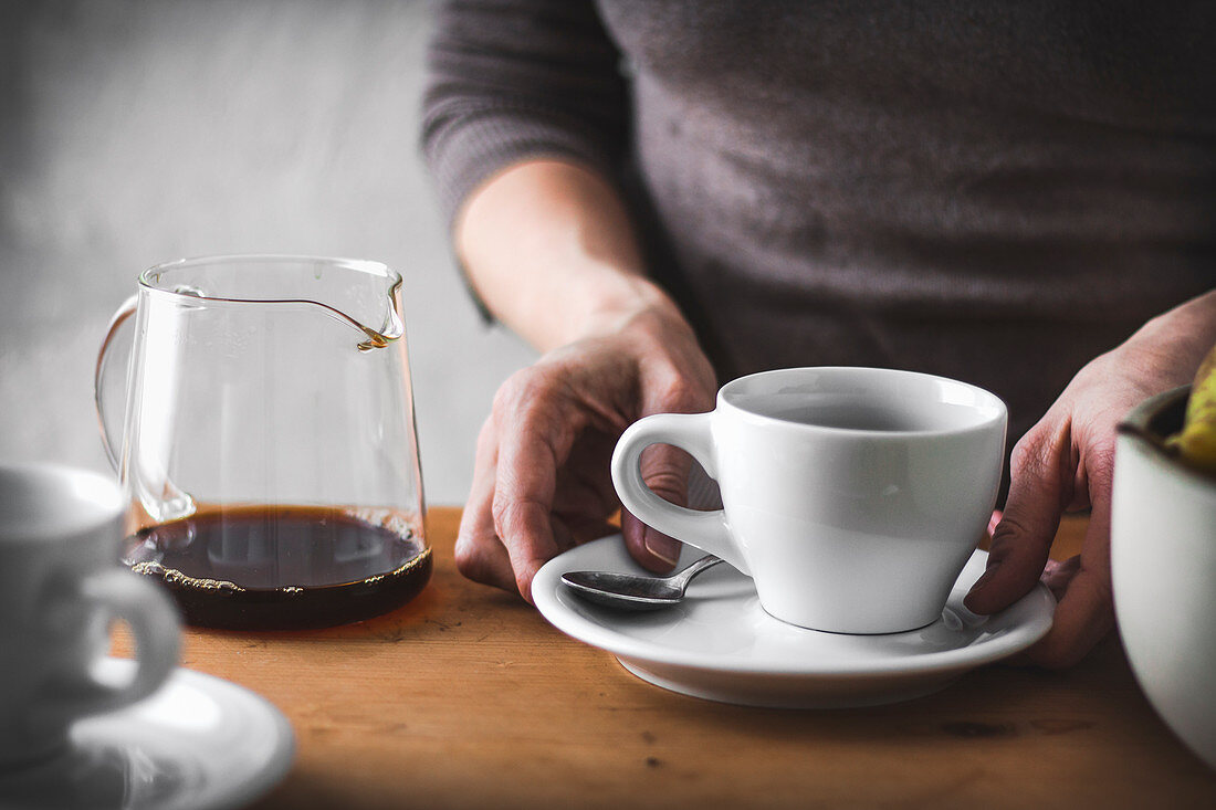 Woman's hands with a coffee cup