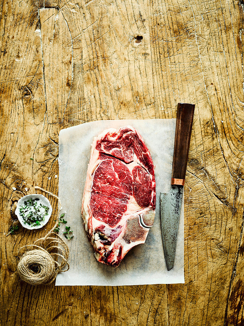 Raw beef steak on greaseproof paper