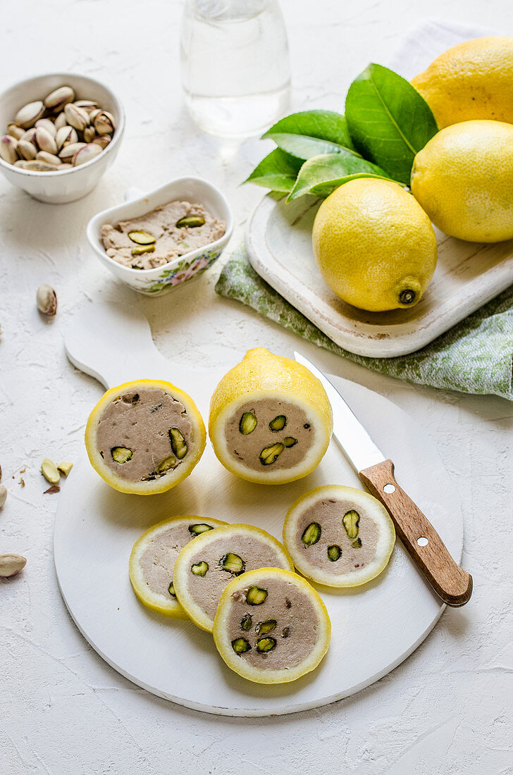 Halved lemons with pistachio and tuna filling