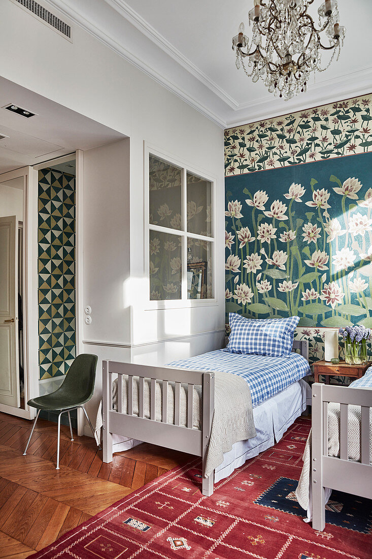 Twin beds against wall painted with water lilies