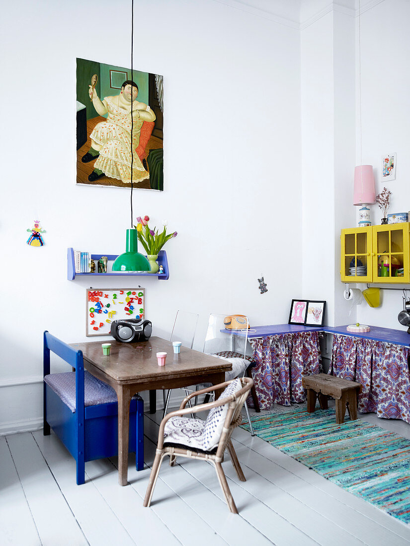 Old wooden table, blue bench and chairs in child's bedroom
