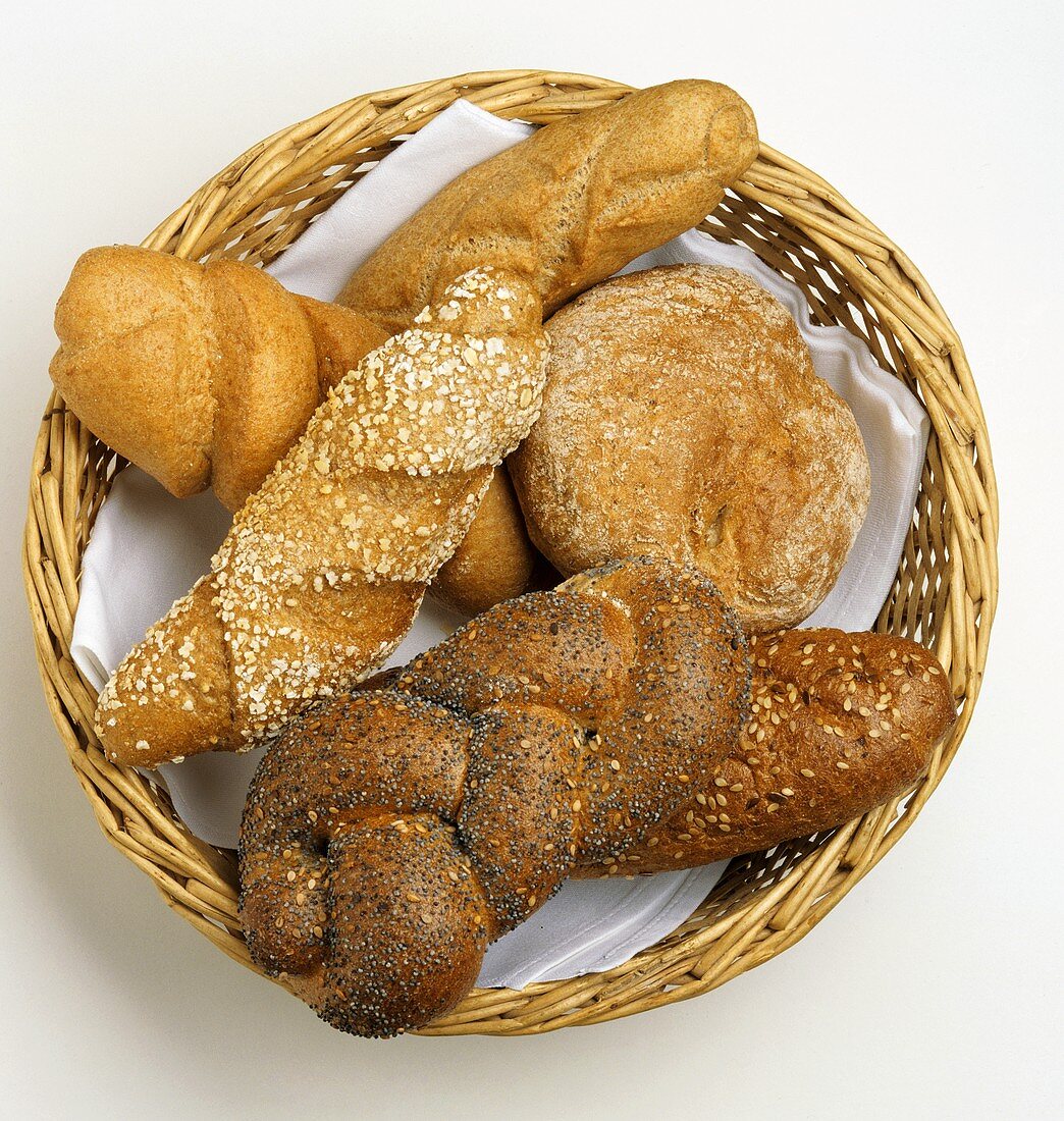 Bread basket with brown stick rolls, rolls & poppy seed plait