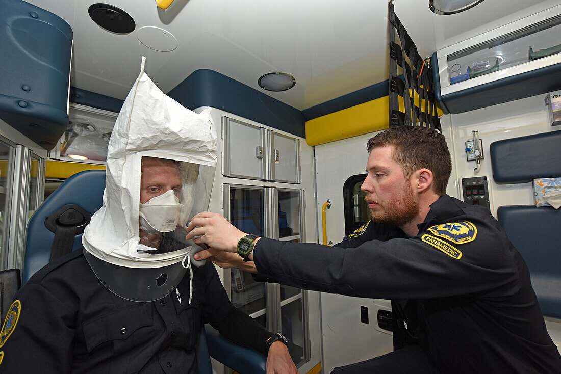 Paramedics testing fit of face mask